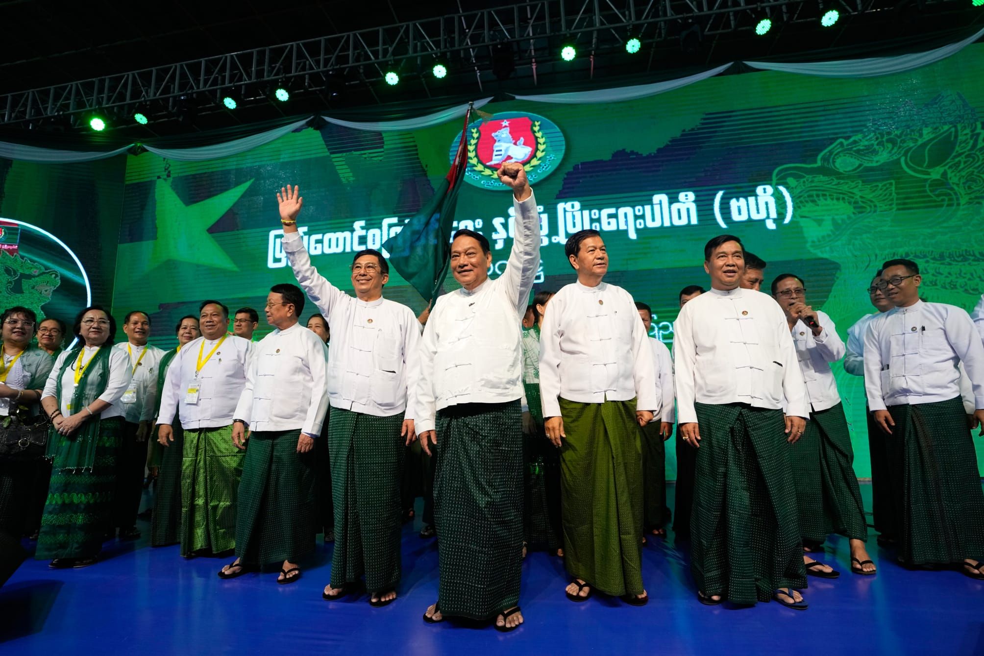 Khin Yi, center, cheers together with party members during a campaign event in Yangon, 19 November 2025. (AP Photo/Thein Zaw)