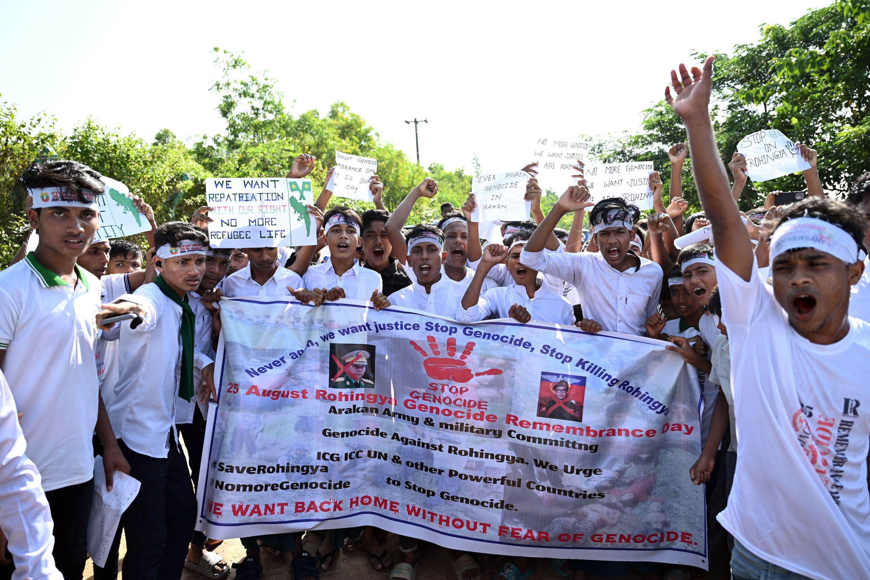 A group of people holding sign